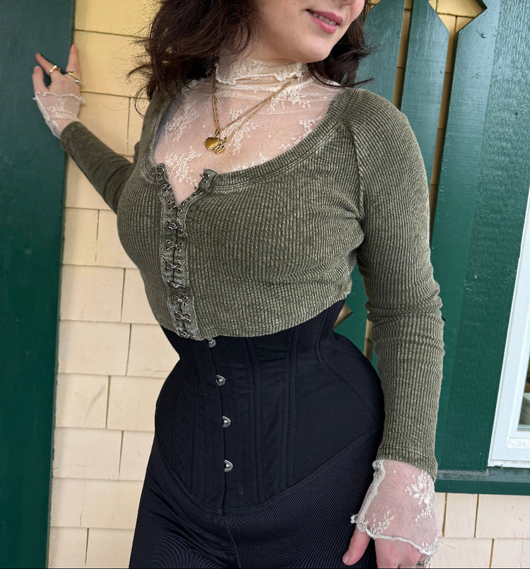 zoya corset worn under a crop sweater