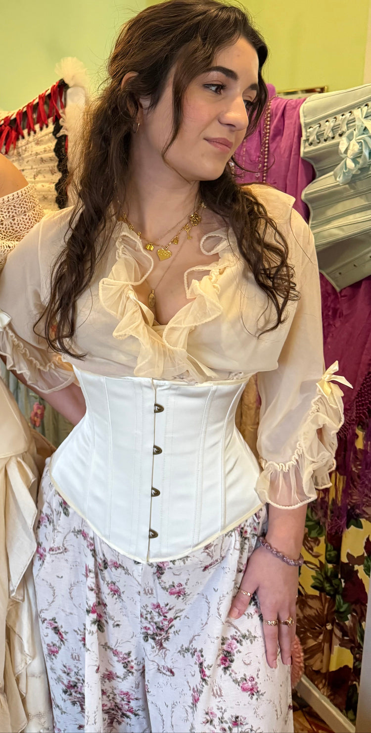 Ivory satin cincher corset on a Young woman in a floral dress