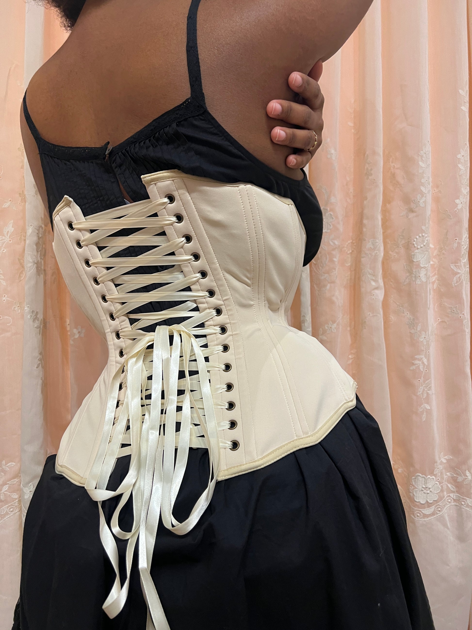 Person wearing a black slip and Myrtle Girdle Corset Petite in Beige on a neutral background