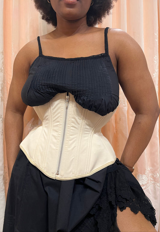 Person wearing a black slip and Myrtle Girdle Corset Petite in Beige on a neutral background